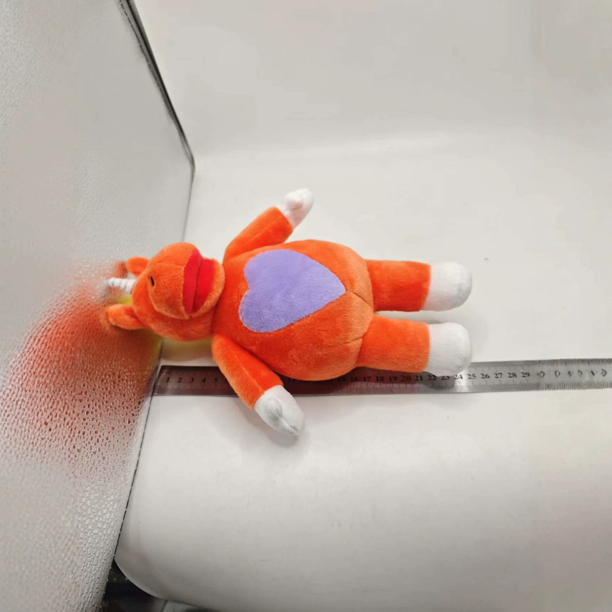 Creepy orange unicorn mascot toy from the 90s TV-style horror movie It's Buddy!