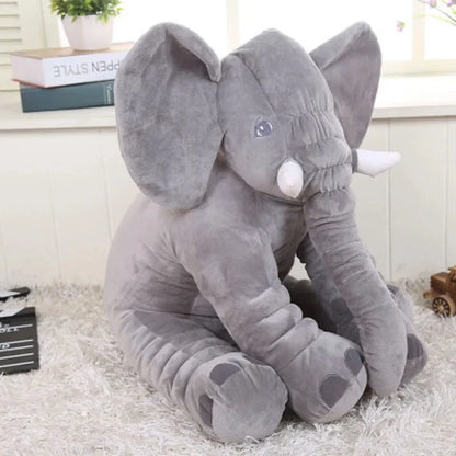 Cuddly elephant stuffed animal being hugged by a child's arm