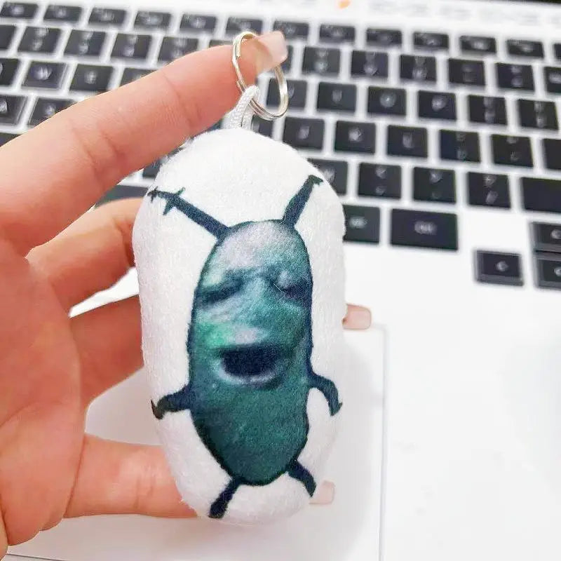 Cursed Plush Keychain hanging on backpack bag strap