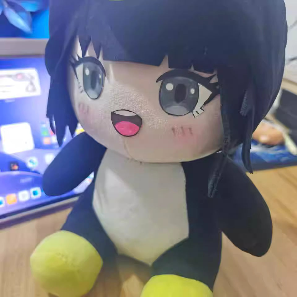 Cute Endmin penguin plush toy displayed on bookshelf with anime figures
