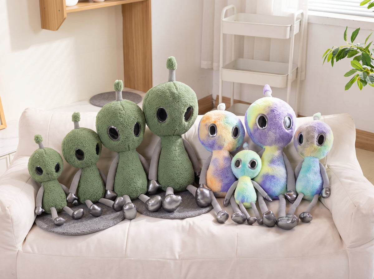 Cute alien stuffed animal with oversized glossy eyes in purple colorway