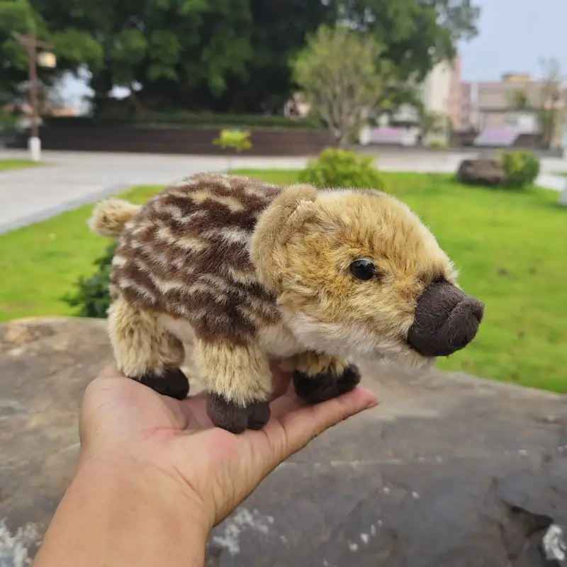 Cute baby boar plush toy showing natural cream and brown stripe camouflage pattern