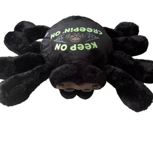 Cute black jumping spider plush with removable clothes sitting upright on white background