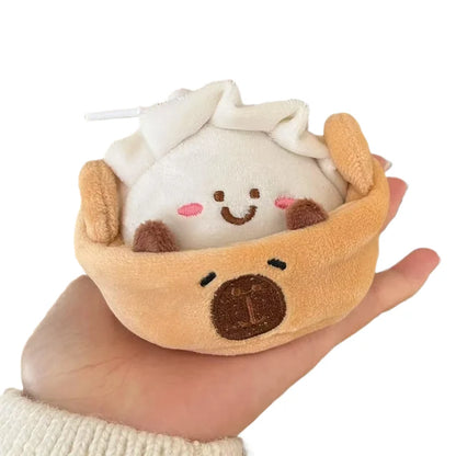 Cute capybara keychain with hide and seek plushie peeking out of steamer basket pouch