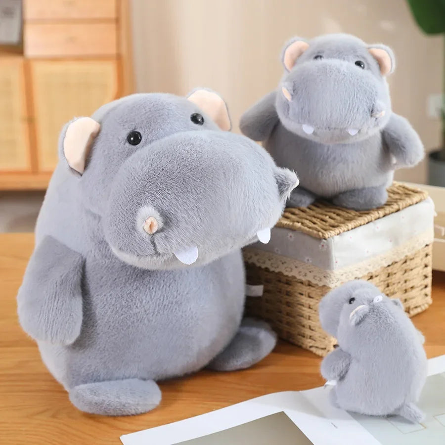 Cute hippo plush close-up showing wide-set eyes and gently parted mouth expression