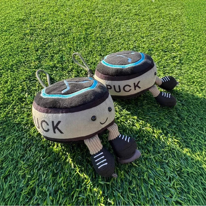 Cute hockey plush puck stuffed toy wearing miniature ice skates close up detail