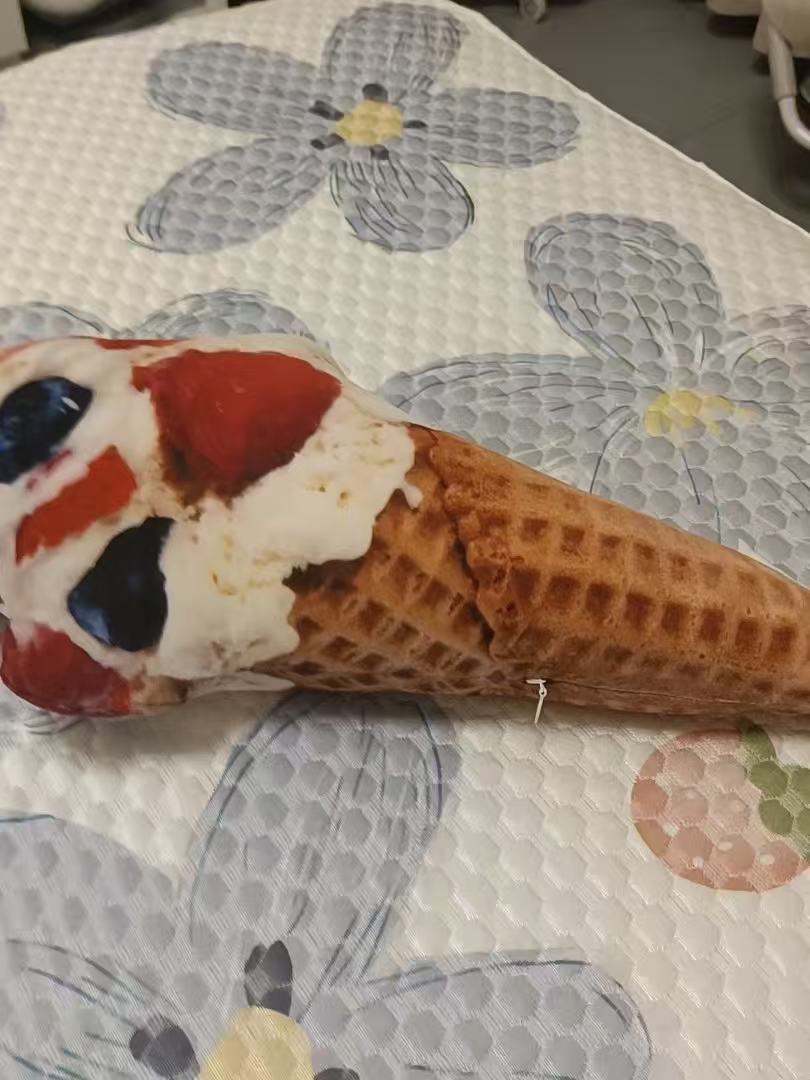 Cute ice cream stuffed animal in mango raspberry twist, orange and pink swirl on waffle cone