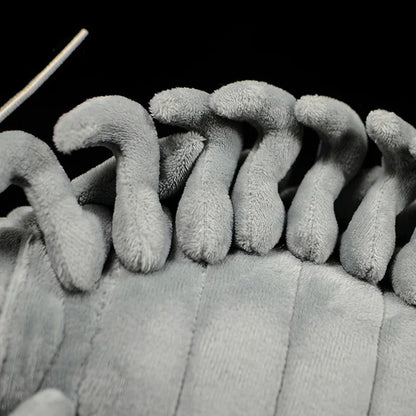 Cute isopod plush being held in hands to show scale