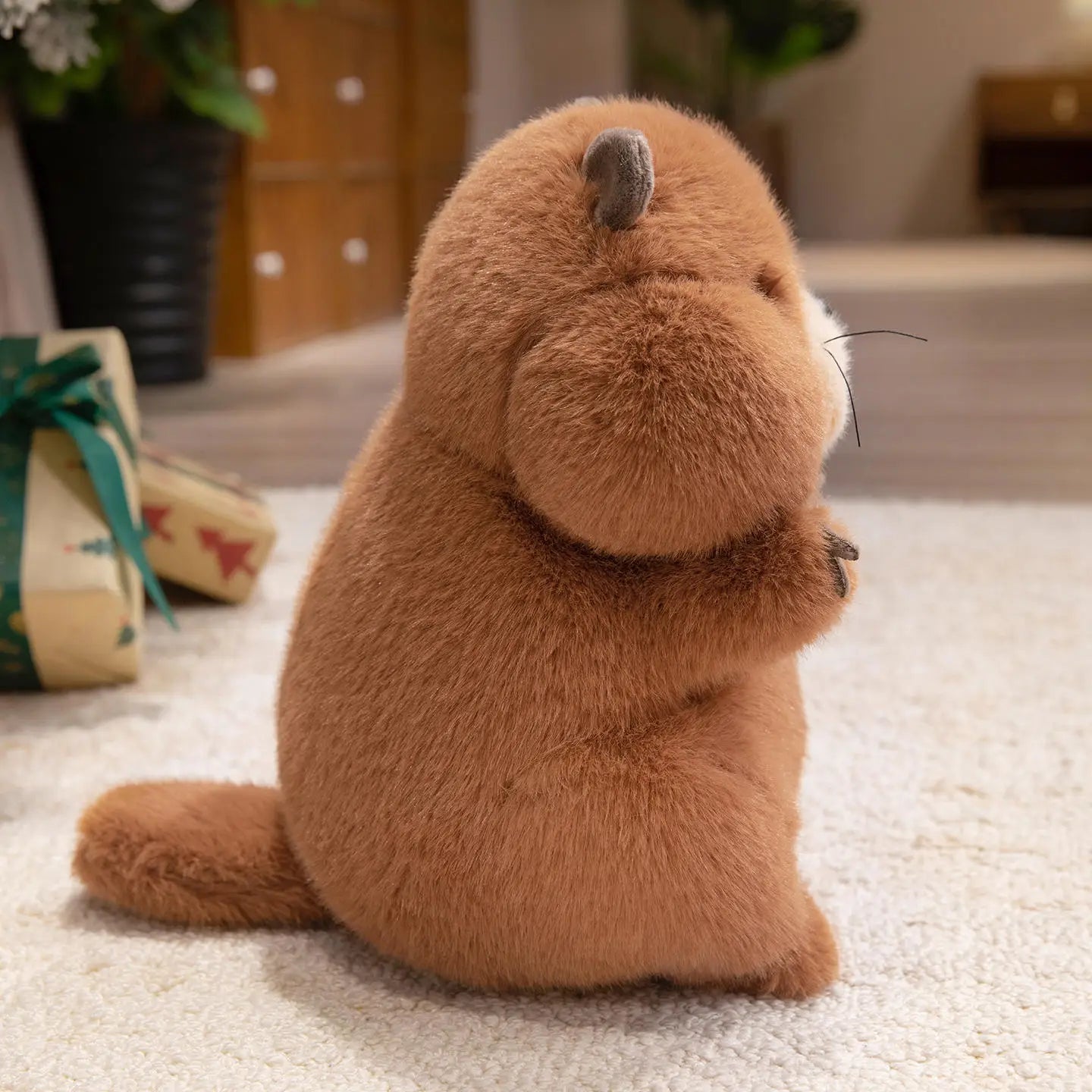 Cute marmot toy close-up showing stitched face details and fluffy cotton material