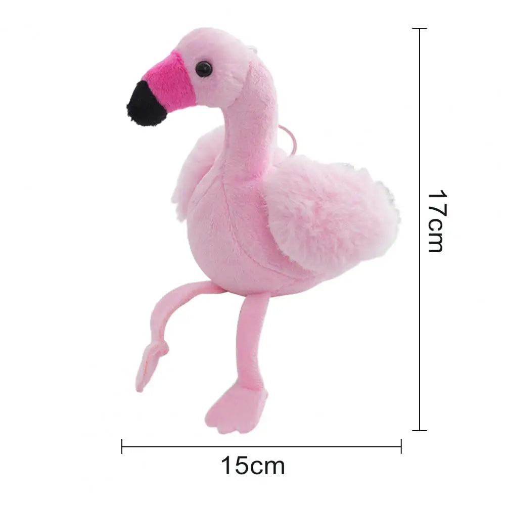 Cute pink flamingo bag charm dangling from a set of house keys on a white marble table top