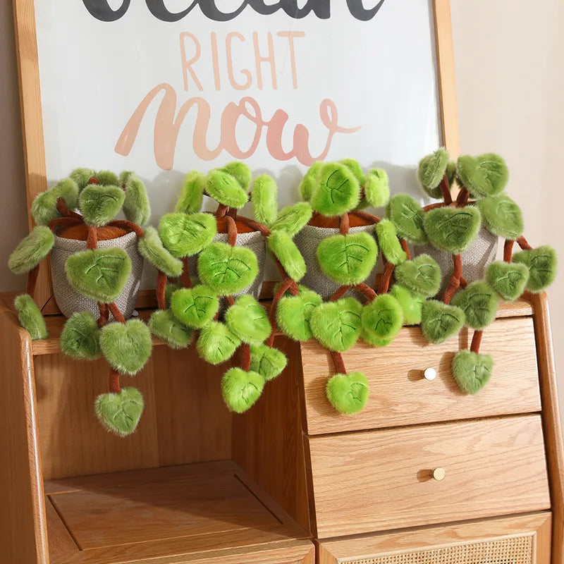 Cute plant plushie pothos on minimalist aesthetic desk with journal