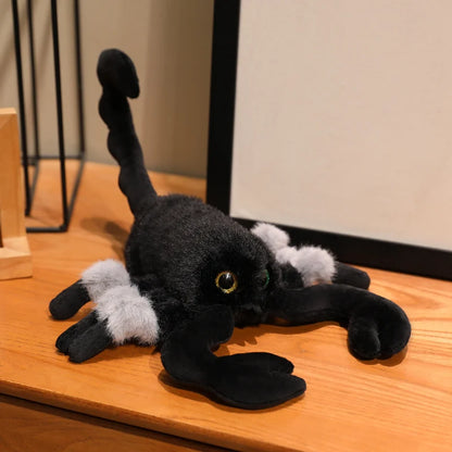 Cute scorpion stuffed animal toy held in hand showing scale and softness