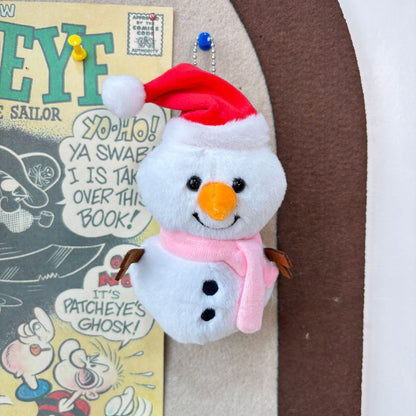 Cute snowman keychain plush bag charm attached to tote bag close-up