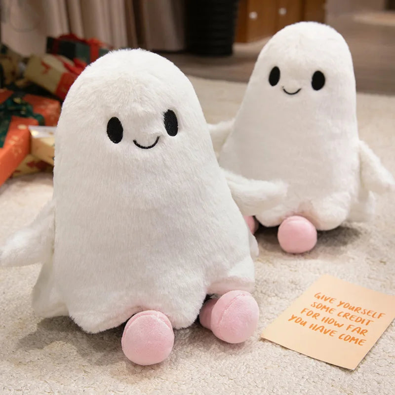 Cute white ghost stuffed animal with pink feet, close-up of facial details