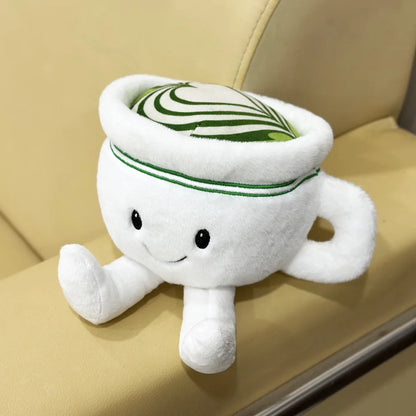 Desk buddy plush matcha cup beside keyboard aesthetic desk setup
