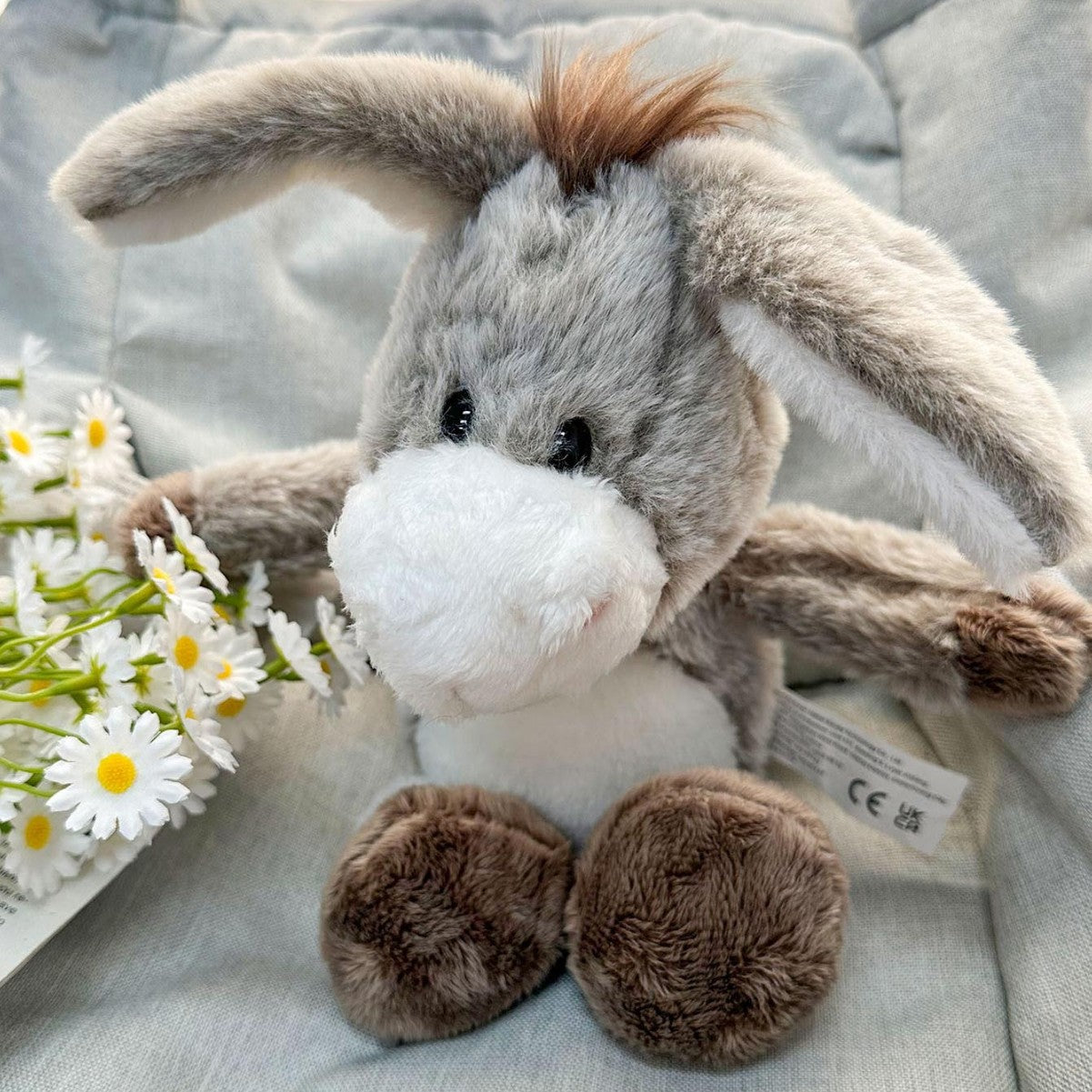 Donkey stuffed toy side profile showing tail and ear detail
