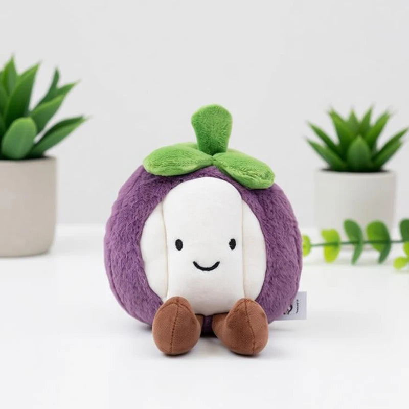 Dragon fruit and strawberry kawaii fruit plush toys displayed together on desk