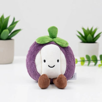 Dragon fruit and strawberry kawaii fruit plush toys displayed together on desk
