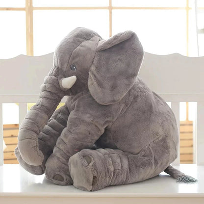 Elephant crib pillow toy propped up on a glider chair