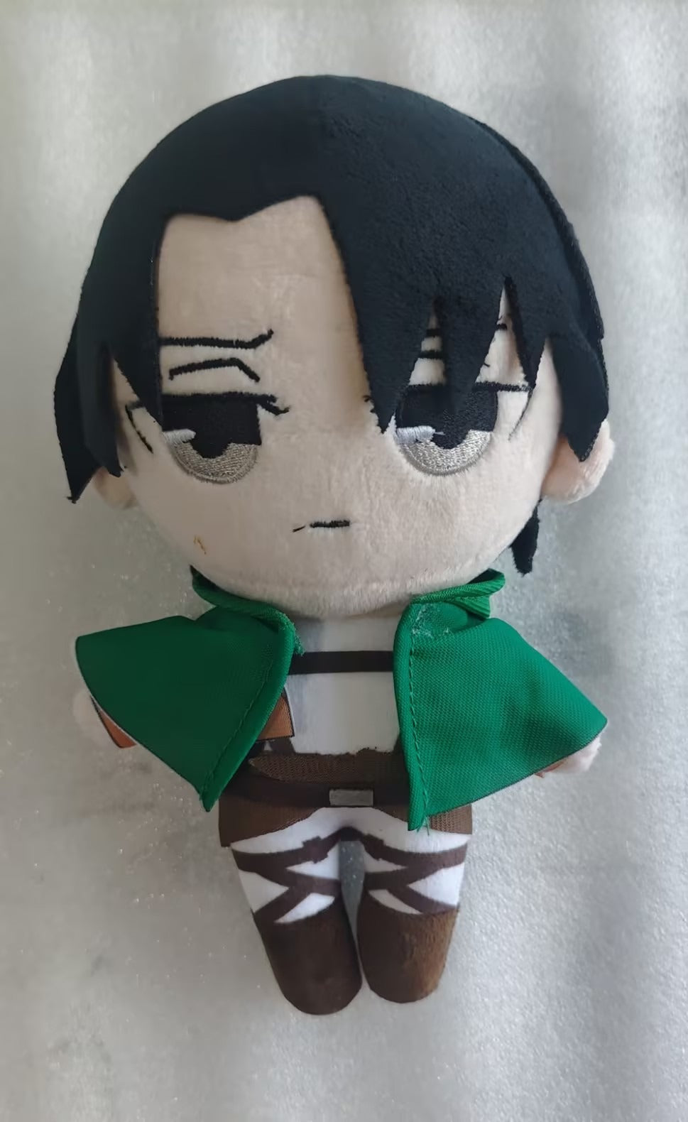 Eren plush seated display pose on shelf, anime character collectible (supplier photo)
