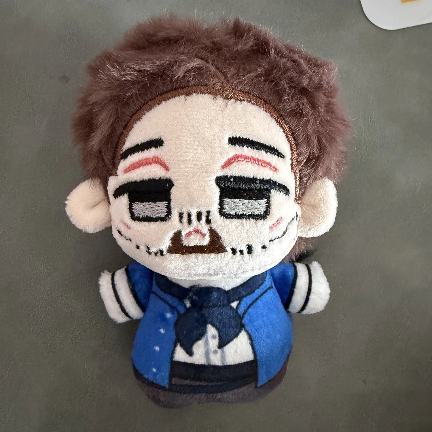 Escuella plush figure 10cm size comparison next to common object
