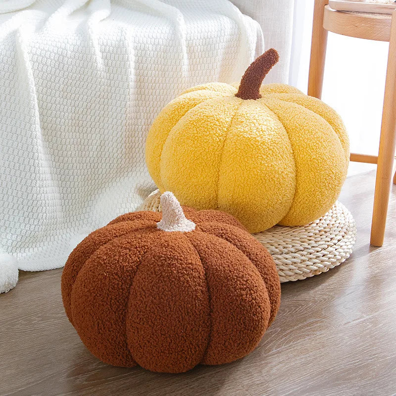 Fall plush toy pumpkin cushion styled in a cozy reading nook with candles