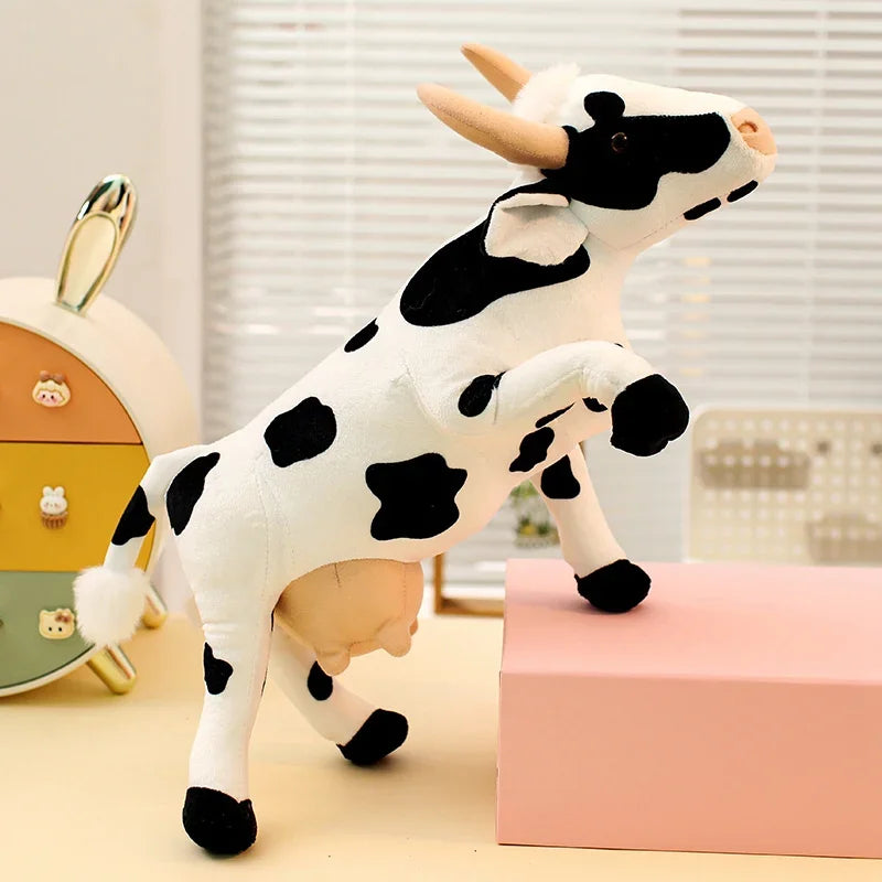 Farm animal plushie cow and companion plushies displayed together on a shelf