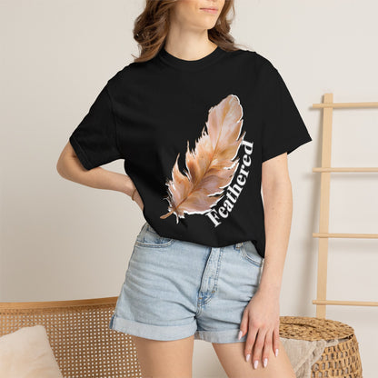 Feather graphic tee laid flat on wooden surface showcasing relaxed unisex fit
