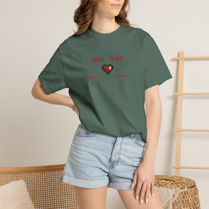 Female model wearing game over shirt in oversized relaxed fit tucked into high waist joggers in a warm indoor setting
