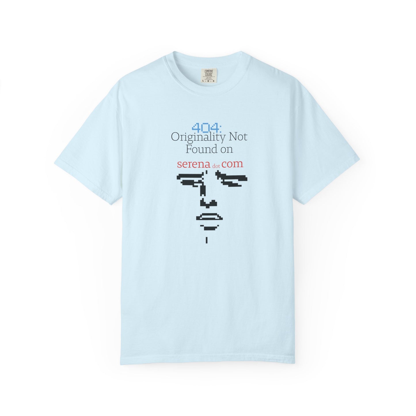 Flat lay of 404 graphic tee on neutral background displaying full pixelated face and error line
