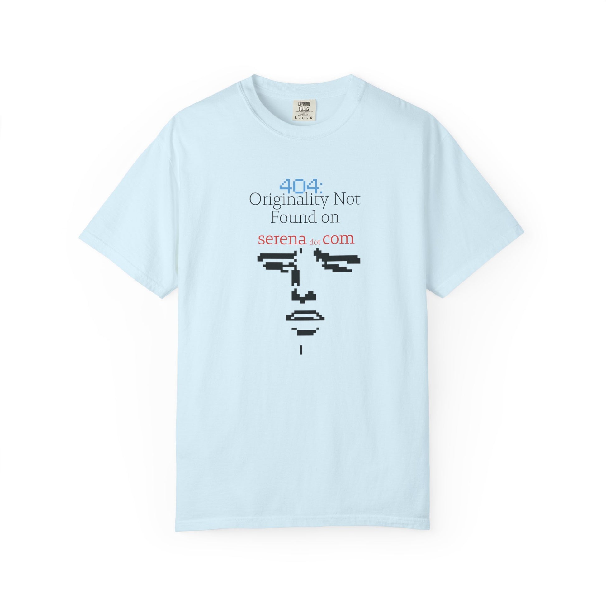 Flat lay of 404 graphic tee on neutral background displaying full pixelated face and error line

