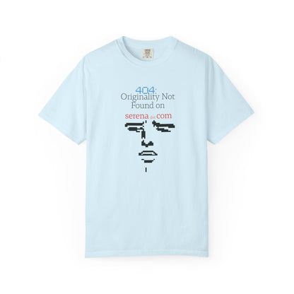 Flat lay of 404 graphic tee on neutral background displaying full pixelated face and error line
