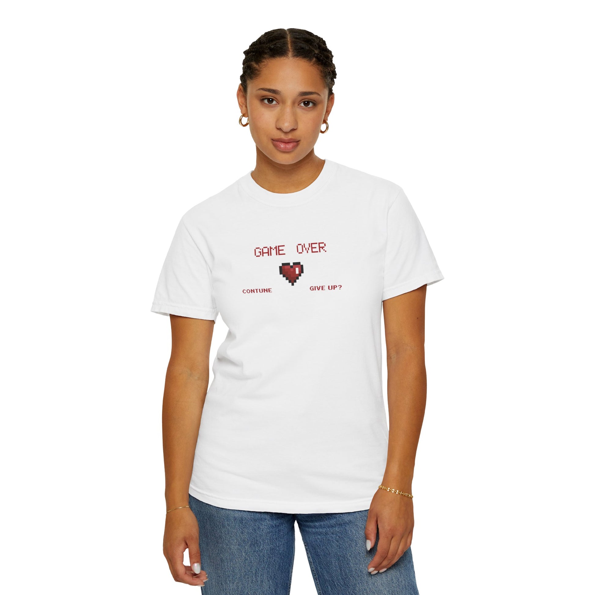 Flat lay of pixel heart tee in warm garment dyed tone showing tubular knit texture and sewn in label
