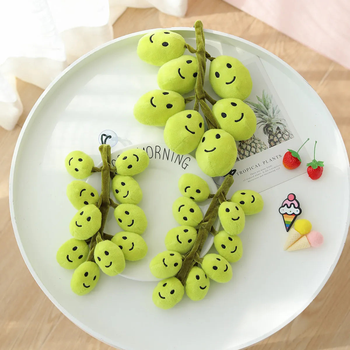 Flexible squishy grape toy held in hand showing soft cotton texture and cluster shape