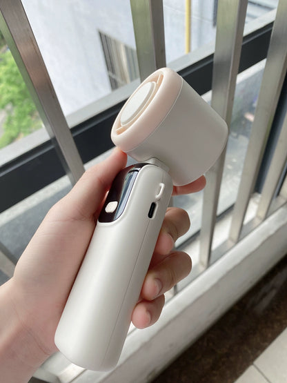 Foldable handheld fan in gray showing 100% battery on digital display screen
