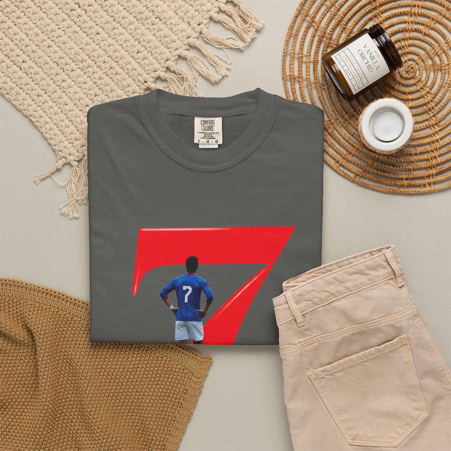 Football graphic tee with blue kit player inside bold red number 7