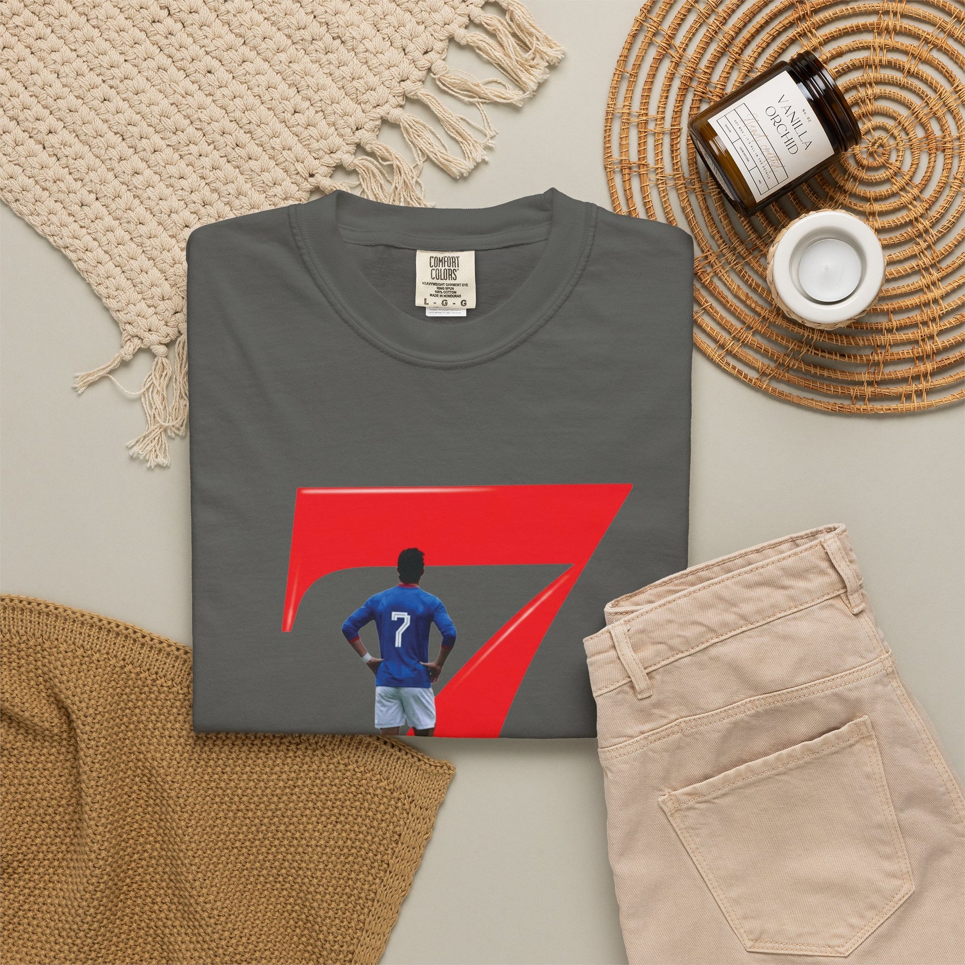 Football graphic tee with blue kit player inside bold red number 7