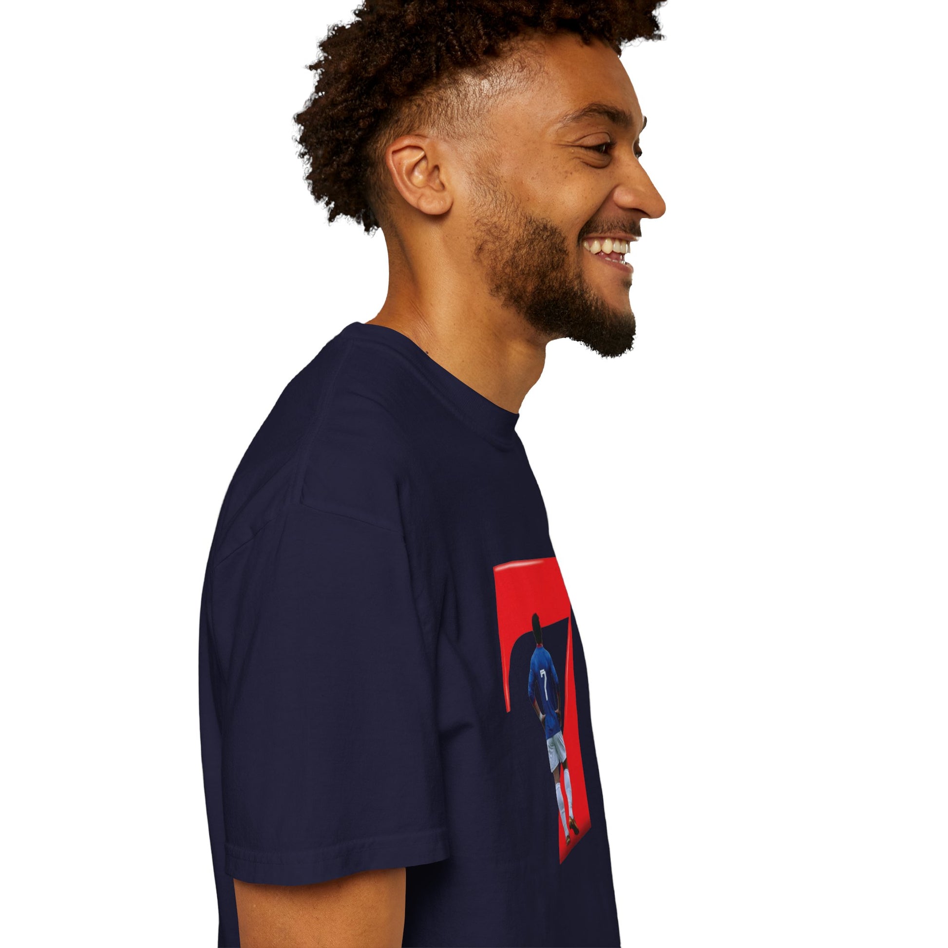 Footballer in blue kit arms outstretched inside bold red 7 on cotton tee