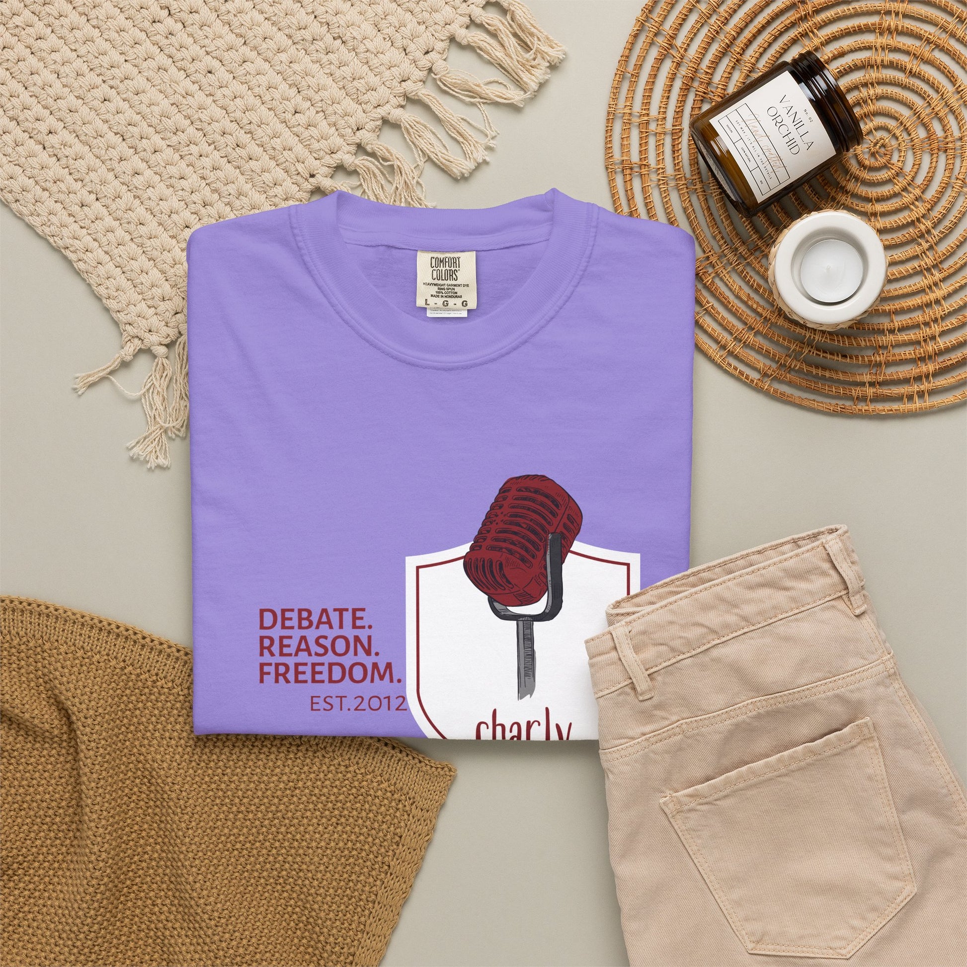 Free speech shirt gift for public speaker folded neatly beside a vintage microphone on a wooden desk