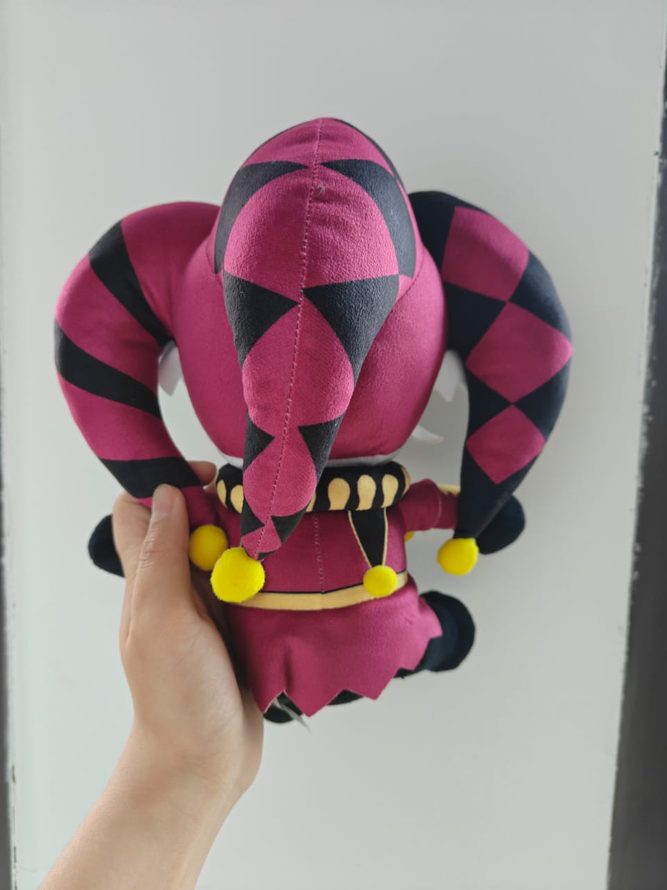 Front view of a handmade 25cm Pierrot jester plush toy from a circus horror visual novel, isolated for a clear product display.