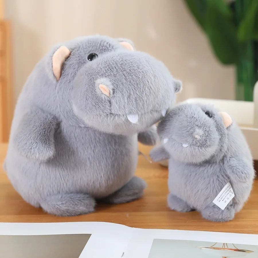 Funny animal plush grey hippo stuffed toy on wooden shelf with other kawaii collectibles