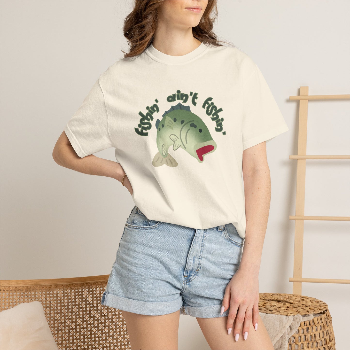 Funny fish aint fishing tee worn by angler at lakeside dock