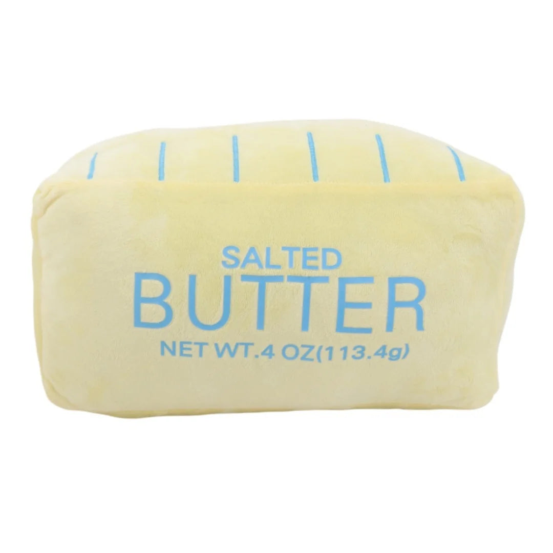 Funny food pillow butter stick plush propped casually against couch cushions