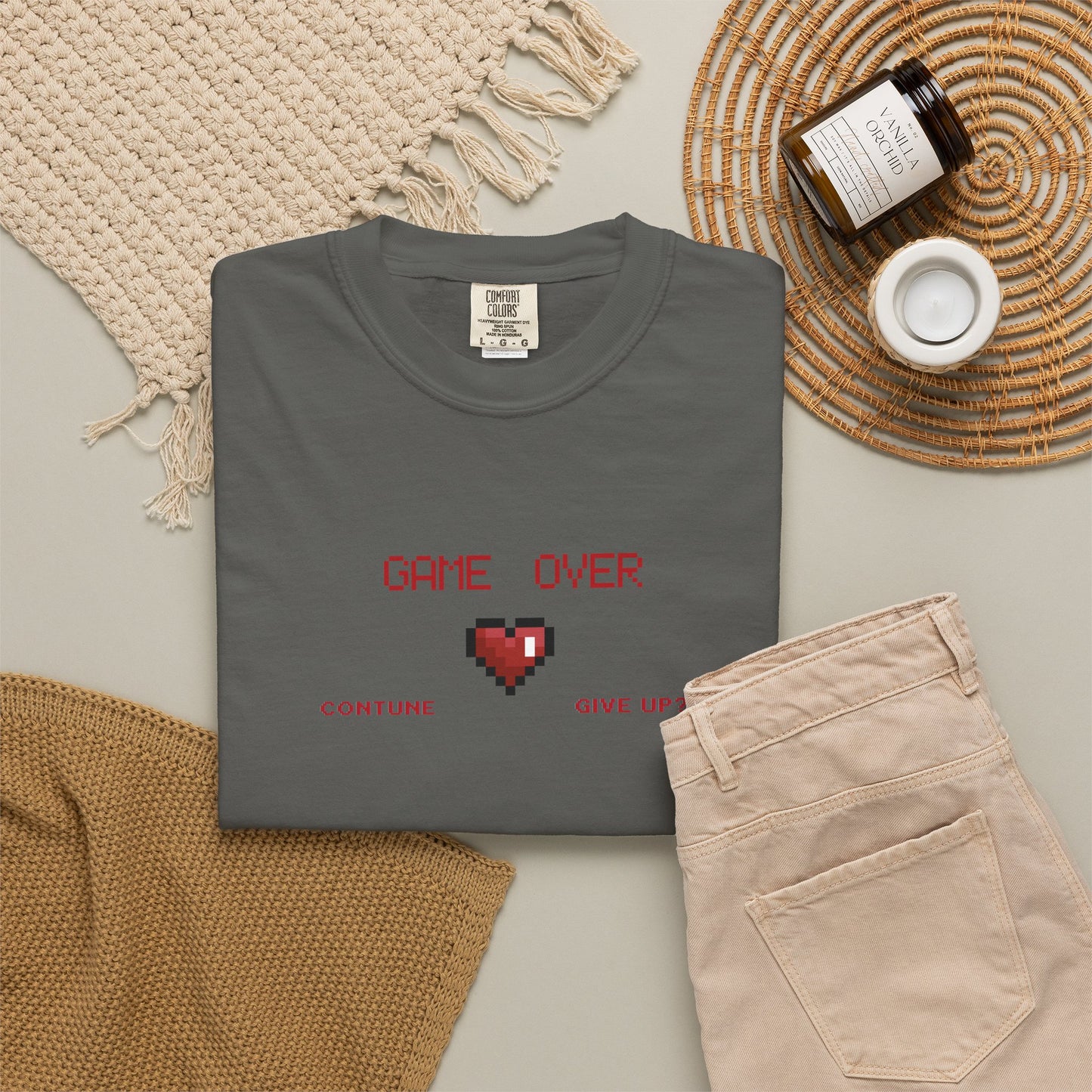 Game over shirt worn at casual game night setting with friends and controllers on the table
