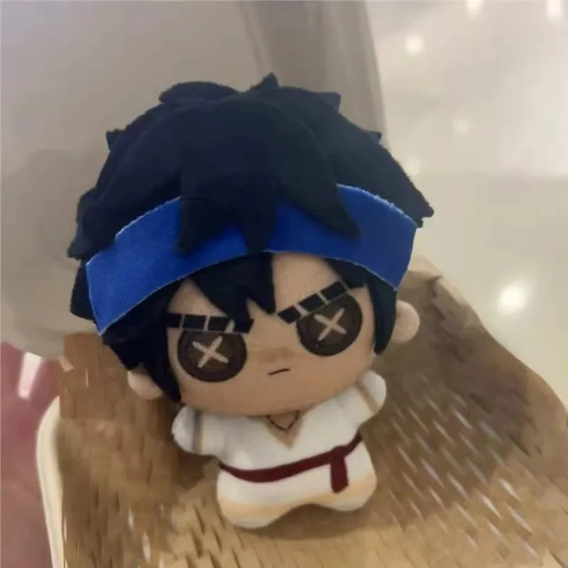 Ganji Gupta Identity V plush displayed on a desk next to other Identity V collectibles
