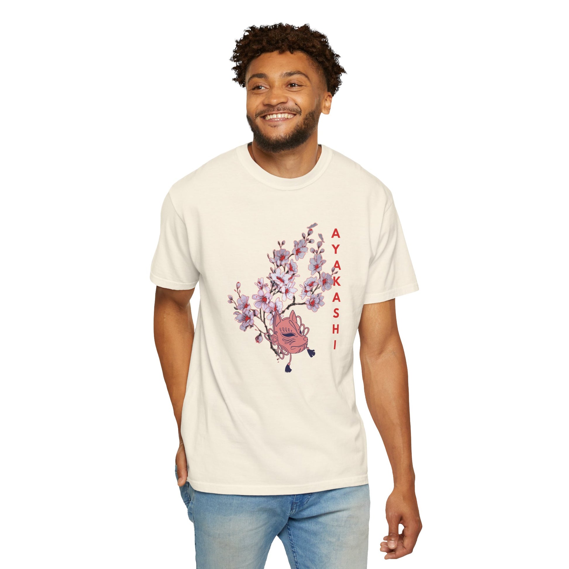 Garment-dyed cotton tee with muted washed tone and yokai mask blossom graphic