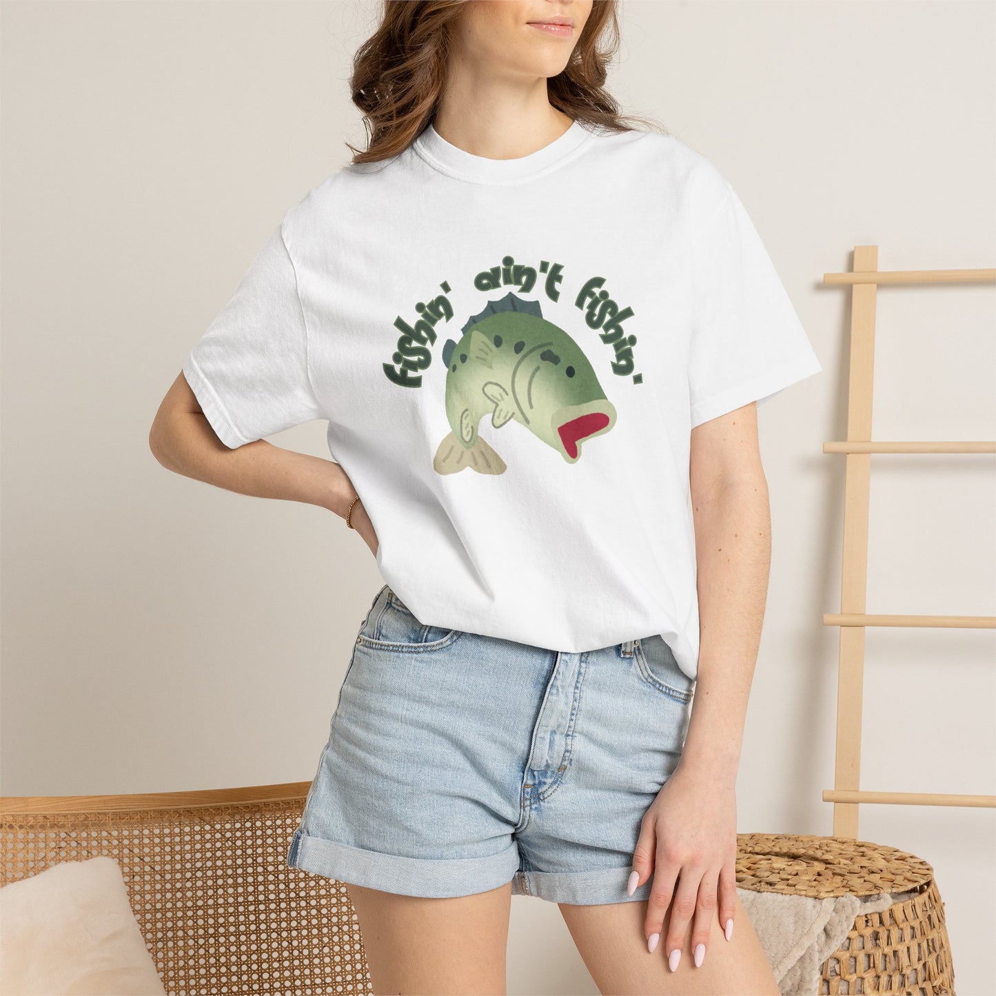 Garment dyed bass tee with fishin aint fishin slogan on cream background