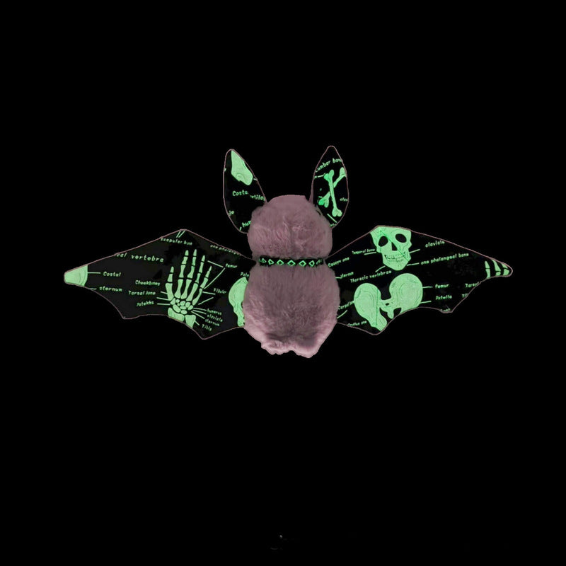 Glow in the dark stuffed animal bat displayed in dark room