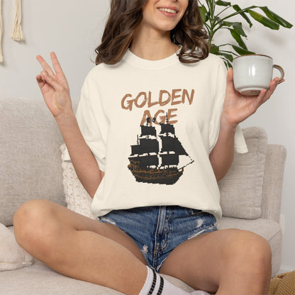Golden age tees unisex flat lay on a dark navy background with compass props
