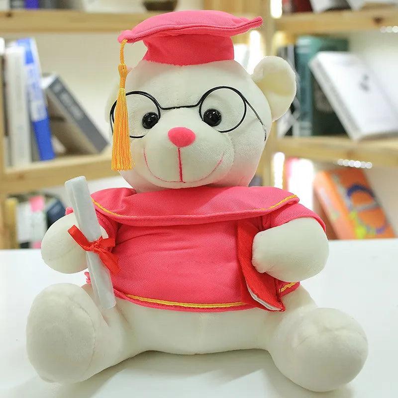 Graduate bear plush used as graduation party table decoration with cap and diploma
